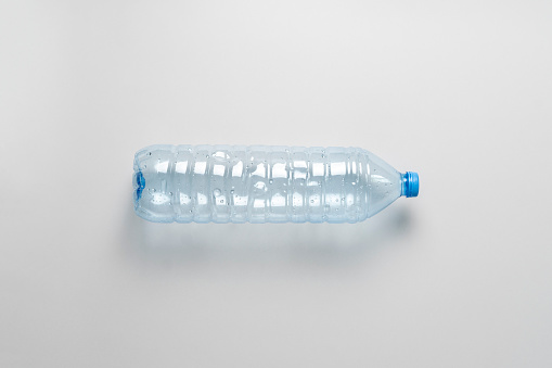 High angle view of pressed used plastic water bottle