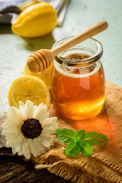 istock Honey with fresh lemon on wooden table background,  honey dipper 1440136895