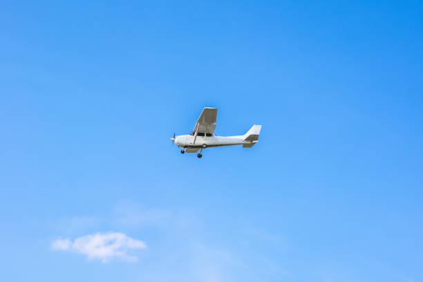 istock Light private airplane in the cloudless blue sky 1440137316