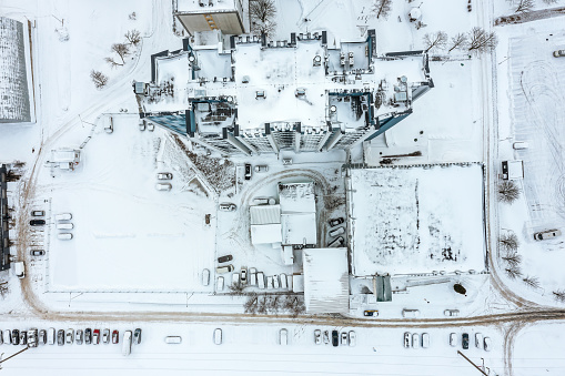 snow-covered roof of high-rise office building. aerial overhead view.