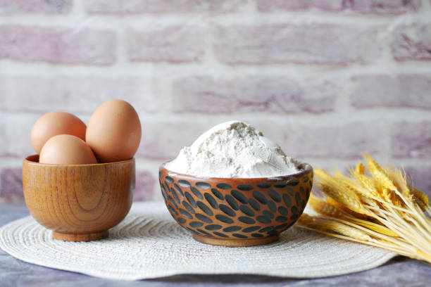 istock wheat flour in a bowl and wheat ears on table 1440141673