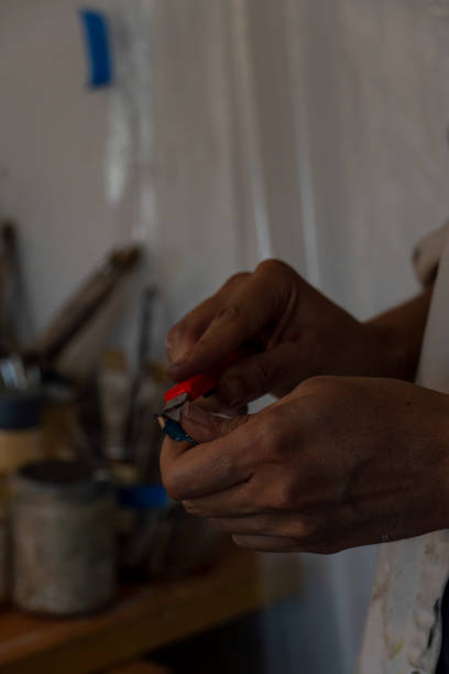 istock young latin woman, in her own painting studio, creates paintings different artistic techniques 1440143847