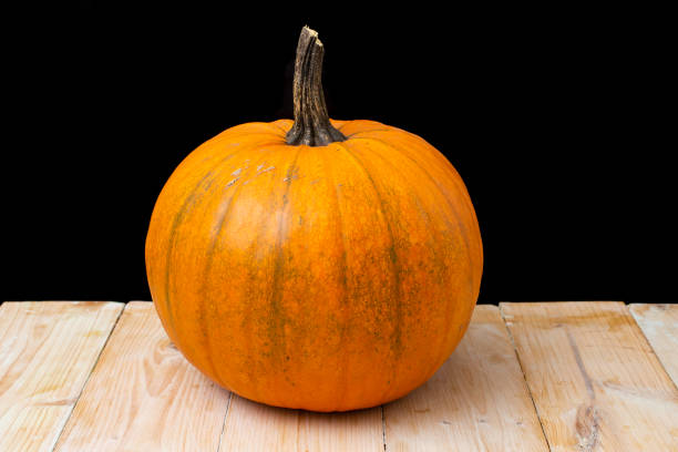 istock Orange pumpkin on woodboards table 1440143977