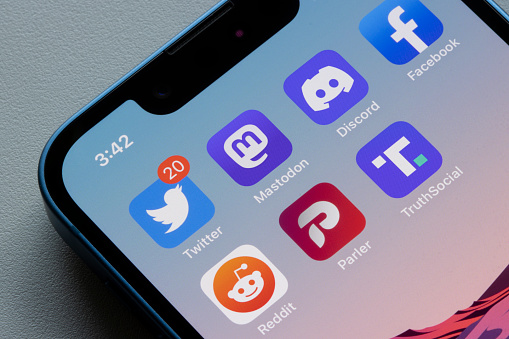 Portland, OR, USA - Nov 8, 2022: App icons of Twitter and some of its alternatives, including Mastodon, Discord, Facebook, Reddit, Parler, and Truth Social, are seen on an iPhone. Mastodon, a decentralized social media platform, is rapidly gaining users after Elon Musk's Twitter takeover.