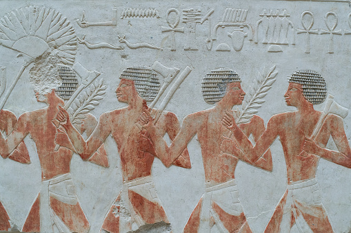 Nubian foot soldiers on an ancient Egyptian relief of painted limestone. New Kingdom 18th Dynasty from the temple of Queen Hatshepsut.