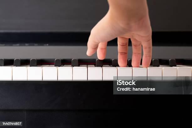 Closeup To Adult Compose Right Hand And Press The Piano Key Practicing Music Instrument Stock Photo - Download Image Now