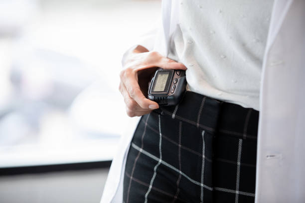 istock Unrecognizable doctor checks pager for message 1440146287