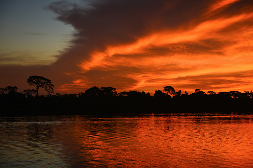 Dramatic sunset on the Guaporé - Itenez river, Ricardo Franco village, Vale do Guaporé Indigenous Land, Rondonia, Brazil, on the border with Bolivia