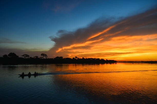 A motorized canoe at sunset on the Guaporé - Itenez river stock photo