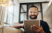 istock Black man, tablet and smile for social media post, shopping online or browsing internet creative content at home. Young africa american happy, relax and calm on tech digital app on device 1440149713