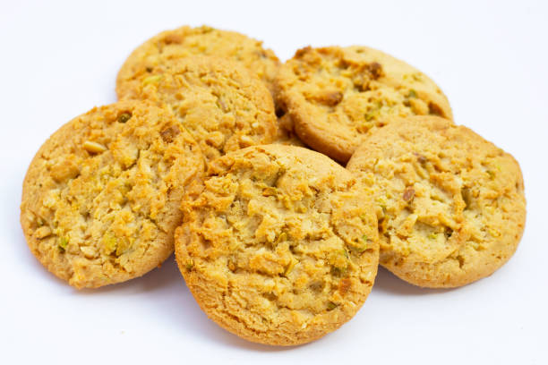 Pistachio and almond cookies on white background.