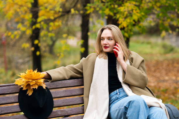 istock Woman on park bench in autumn 1440156882