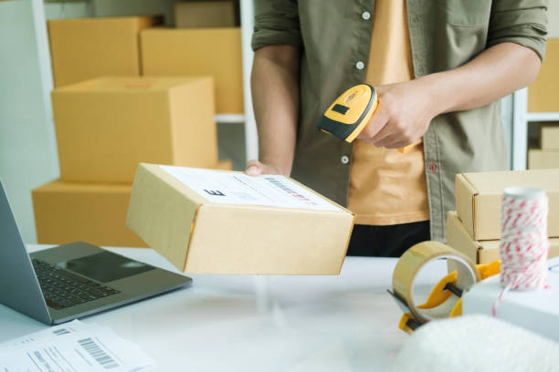istock Young entrepreneur scanning online order box. 1440156892