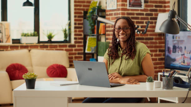 istock Young employee using laptop doing remote job at home 1440156897