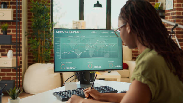 istock Young adult looking at annual sales report data on computer 1440157395