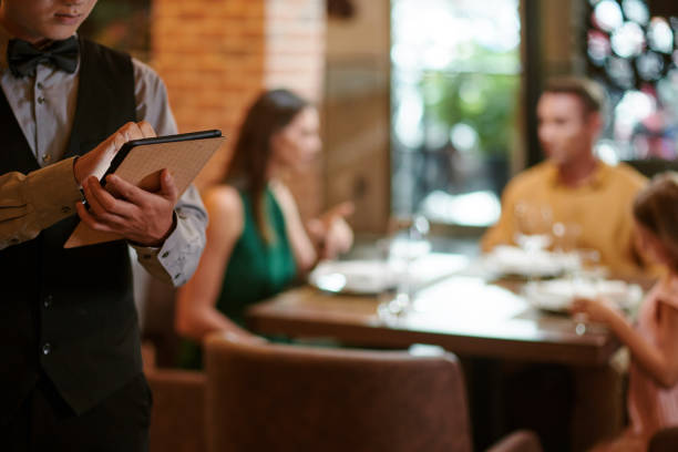 istock Restaurant Waiter Writing Order Details 1440158192