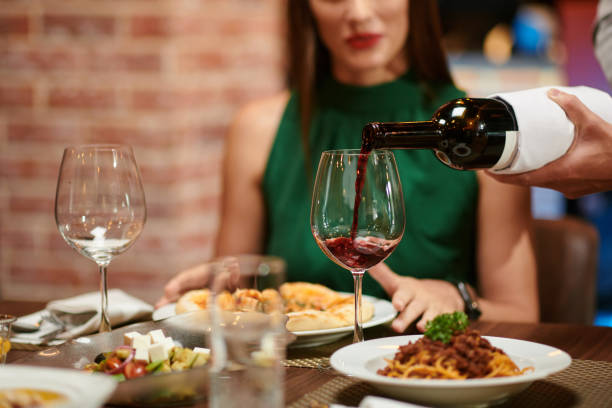 istock Waiter Filling Wine Glass 1440158217