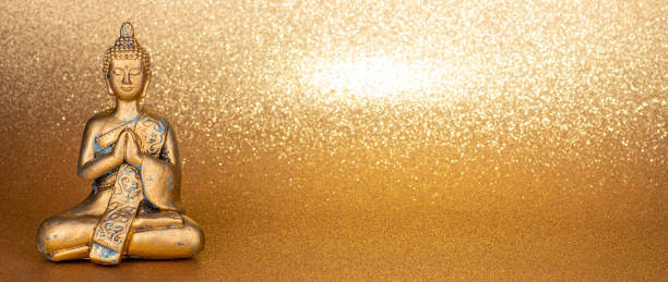 istock golden buddha in front of a gold glittering background 1440160732