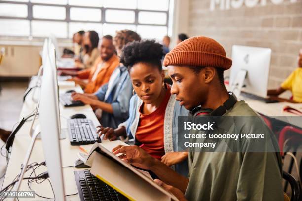 Reading Computing Two College Students Reading A Textbook During Computer Class Stock ...