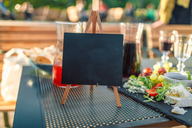 Black table with blurred bokeh restaurant background with blackboard menu and copy space.