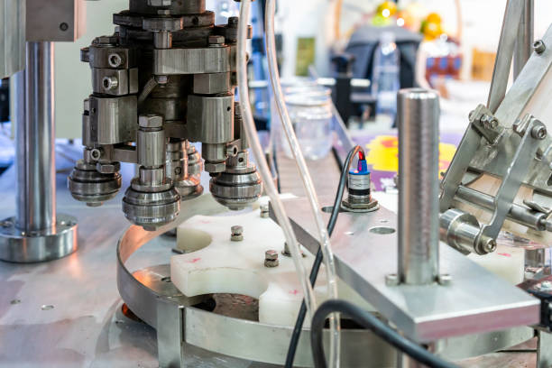 istock Close up capping head or sealing roller component of can cap seamer machine for manufacturing process in food or beverage filling and packing industrial 1440164223