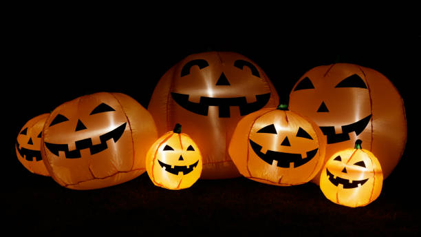 istock Inflatable pumpkins glowing in the dark for Halloween decorations. 1440165937