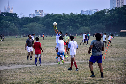 Adult Soccer Players Compete in a Tournament Match. Footballers in a Duel. Boys Kicking Soccer Ball on Grass Stadium Pitch