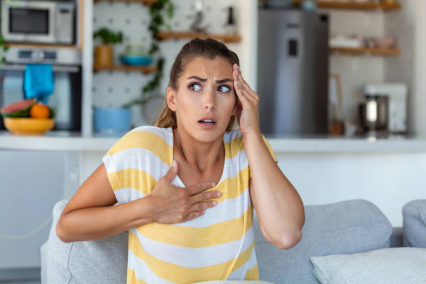 istock Breathing, respiratory problem, asthma attack, pressure, chest pain, sun stroke, dizziness concept. portrait of woman received heatstroke in hot summer weather, touching her forehead 1440166270