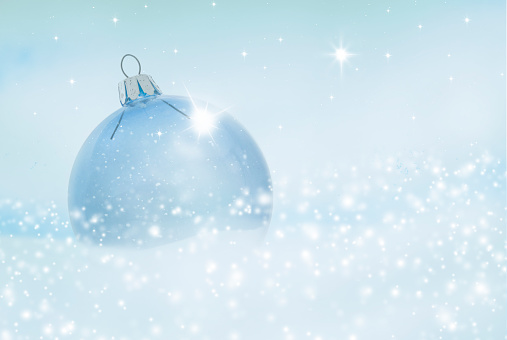 Transparent glass Christmas ball in snow