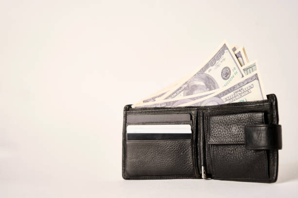 istock Black leather wallet with dollar money on a white background 1440166660