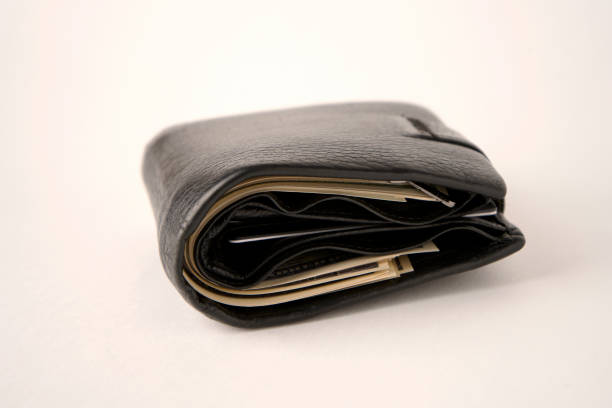 istock Black leather wallet with dollar money on a white background 1440166669