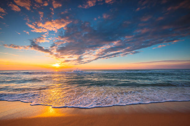 Beautiful sunrise over the sea and beach stock photo