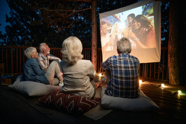 istock Mature couples relaxing during movie night on a terrace. 1440168894