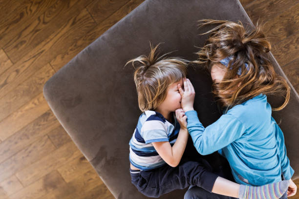 istock Above view of small brothers relaxing on sofa at home. 1440170104