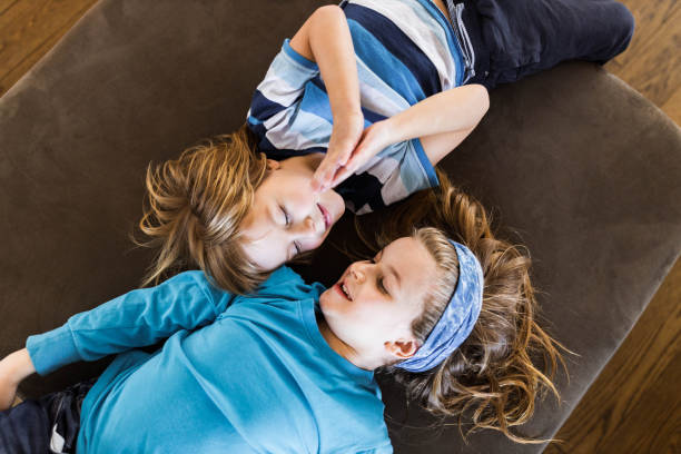 istock Above view of happy boys talking on sofa at home. 1440170161