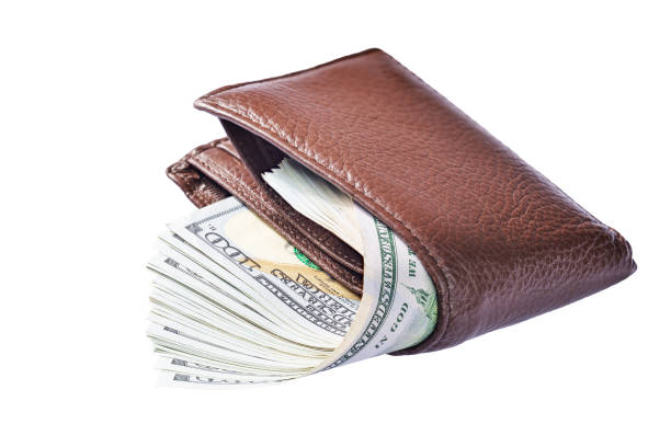 istock Brown leather wallet with many hundred dollar bills isolated on white background. 1440170192
