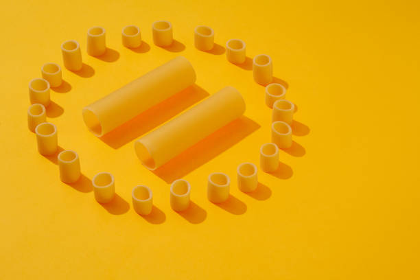 istock raw pasta on a bright yellow background. Food pattern 1440172194