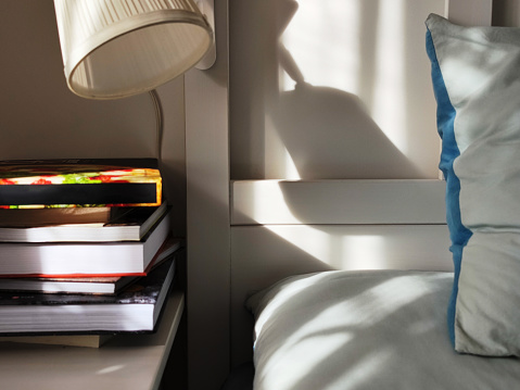 morning sunlight on pillows and bedside table