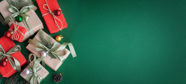 Banner with Christmas gift and decorations on green background.