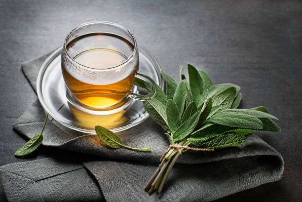 istock Sage tea in glass mug and sage leaves 1440179251