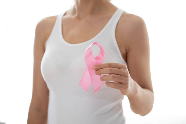 istock young woman showing pink ribbon 1440181006