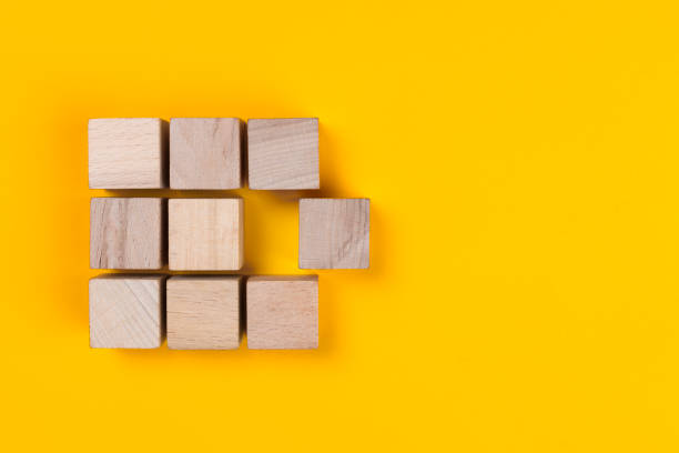 istock Wooden cube block group and another cube block detached from the group 1440181164
