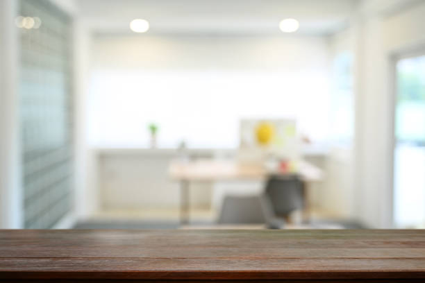 istock Empty wood table against blurred bright home office interior background. Copy space for your product display or design montage. 1440181404