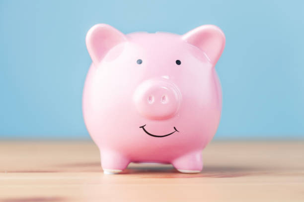istock Piggy bank on wooden table 1440182449