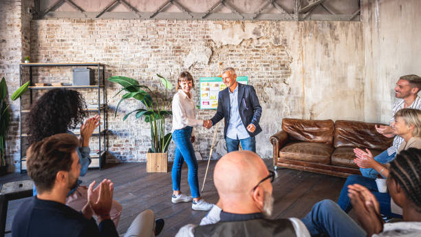 istock Handshake between mature businessman and young creative expert, colleagues applause sitting 1440184038