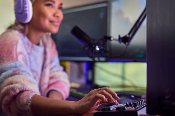 istock Woman Gaming At Home Sitting At Desk With Multiple Monitors 1440184076
