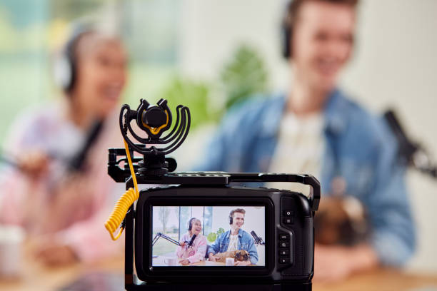 istock Couple With Dog Vlogging Recording Video At Home With Camera 1440184127