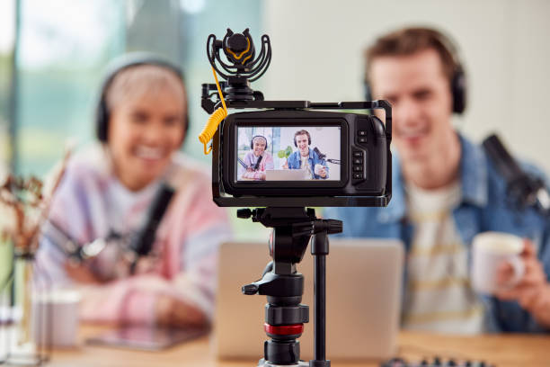 istock Couple Vlogging Recording Video At Home With Camera 1440184540