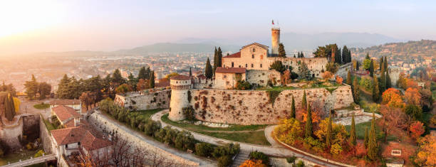 Panoramic drone view on medieval fortress Castello di Brescia, via del Castello and historical building complex on Cidneon mountain slope at autumn. Brescia, Lombardy, Northern Italy Brescia - Italy. November 12, 2021: Panoramic drone view on medieval fortress Castello di Brescia, via del Castello and historical building complex on Cidneon mountain slope at autumn. Brescia, Lombardy, Northern Italy brescia stock pictures, royalty-free photos & images
