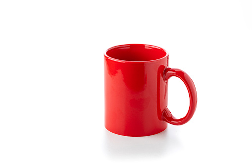 Close up view of a red mug isolated on white background. Copy space available. High resolution 42Mp studio digital capture taken with Sony A7rII and Sony FE 90mm f2.8 macro G OSS lens